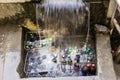 Khorog, Tajikistan August 25 2018: At the roadside on the Pamir Highway in Tajikistan drinks are cooled under a small waterfall