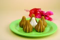 Khoya Modak with red hibiscus flower, an Indian traditional sweet