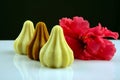 Khoya Modak with red hibiscus flower, an Indian traditional sweet