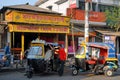 Khulna, Bangladesh: Two auto rickshaws with drivers waiting for passengers on a street in Khulna