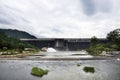 Khun Dan Prakan Chon Dam or Khlong Tha-Dan Barrage Dam while draining from reservoir with thai people and foreign travelers travel