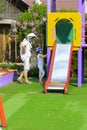 Khust, Ukraine - April 22, 2018. Young children run around playground. Game center for a young child. Little girl and grandmother