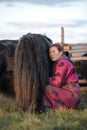 Mongolian woman milking a yak in northern Mongolia.