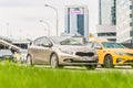 Kia Cee`d Second generation JD accelerating in highway on urban background. Beige hatchback car fast speed drive on city road Royalty Free Stock Photo