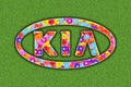 Kia Logo with colorful flowers on green background Royalty Free Stock Photo