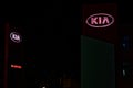 KIA motors car dealer glowing logo at night