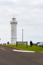 Tourists visiting the blowhole and lighthouse in Kiama, NSW, Australia