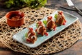 Kibbeh or kibe, quibe, kibbe with mayo dip, chilli sauce and pomegranate seeds served in dish isolated on table top view of arabic