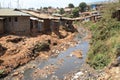 Huge heaps of garbage and a dirty river in the slums of Nairobi - one of the poorest places in Africa