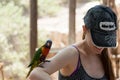 Kibutz Nir David, Israel, June 10, 2017 : Parrot sits on the hand of a young woman at the Australian Zoo Gan Guru in Kibbutz Nir D