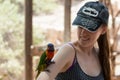 Kibutz Nir David, Israel, June 10, 2017 : Parrot sits on the hand of a young woman at the Australian Zoo Gan Guru in Kibbutz Nir D