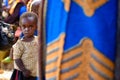 Kibuye/Rwanda - 08/25/2016: African girl hiding behind mother`s