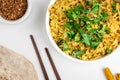 Kichari in a white plate on a light table near condiments and tortillas top view, close-up Royalty Free Stock Photo