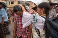 Kichwa woman pouring water on man`s head