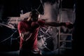 Kick boxer boxing as exercise for the big fight. Boxer hits punching bag. Young boxer trains on punching bag