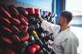 Kick boxer choosing gloves Royalty Free Stock Photo