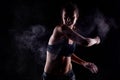 Kickboxer girl with magnesium powder on her hands, punching with dust visible Royalty Free Stock Photo