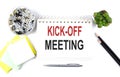 KICK-OFF MEETING text on notebook with office supplies on white background