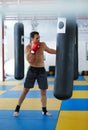 Kickbox fighter training with the punch bag Royalty Free Stock Photo
