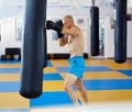 Kickbox fighter training with the punch bag Royalty Free Stock Photo