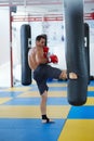 Kickbox fighter training with the punch bag Royalty Free Stock Photo