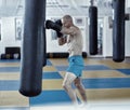 Kickbox fighter training with the punch bag Royalty Free Stock Photo