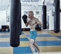 Kickbox fighter training with the punch bag Royalty Free Stock Photo