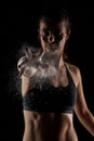 Kickboxer girl with magnesium powder on her hands, punching with dust visible Royalty Free Stock Photo