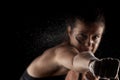 Kickboxer girl with magnesium powder on her hands, punching with dust visible Royalty Free Stock Photo