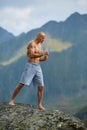 Kickboxer or muay thai fighter training on a mountain cliff Royalty Free Stock Photo