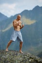 Kickboxer or muay thai fighter training on a mountain cliff Royalty Free Stock Photo