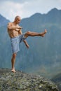 Kickboxer or muay thai fighter training on a mountain cliff Royalty Free Stock Photo