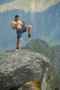 Kickboxer or muay thai fighter training on a mountain cliff Royalty Free Stock Photo