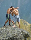 Kickboxers or muay thai fighters training on a mountain cliff