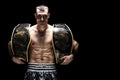 Kickboxing world middleweight champion stands with two belts. The concept of a healthy lifestyle, victory, success. Motivation