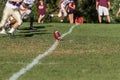 Kicker approaching football on a tee for kickoff