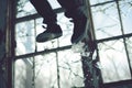 a kickflip captured midair with broken windows background Royalty Free Stock Photo