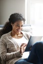 Kicking back to a laid-back weekend. an attractive young woman using a digital tablet at home. Royalty Free Stock Photo