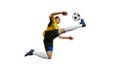 Kicking ball in a jump. Young professional female football, soccer player in motion, training, playing isolated over