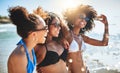 Kicking off summer with a day at the beach. a group of happy young women having fun together at the beach.