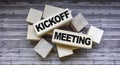 Kickoff meeting text on wooden blocks on wooden background .Money, business and finance concept Royalty Free Stock Photo