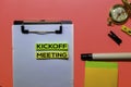 Kickoff Meeting write on sticky notes isolated on Pink background