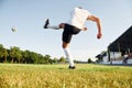 Kicks the ball. Young soccer player have training on the sportive field Royalty Free Stock Photo