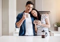 Kickstart the day with coffee and love. a happy young couple having coffee together at home.