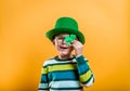 Kid on annual traditional St. Patrick's Day Parade on March in Ireland. Funny kid in star glasses, green leprechaun hat Royalty Free Stock Photo