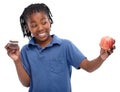 Kid, apple and cupcake in studio with smile for thinking, contemplating and decision on snack. Black child, happy and