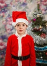 Kid as Santa claus decorating Christmas tree. New year small boy at decoration toy Royalty Free Stock Photo