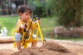 Kid baby boy todler playing construction truck toy diging sand in playground Royalty Free Stock Photo