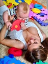 Kid baby boy with mother plying puzzle toy on Royalty Free Stock Photo