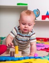 Kid baby boy plying with puzzle toy on floor Royalty Free Stock Photo